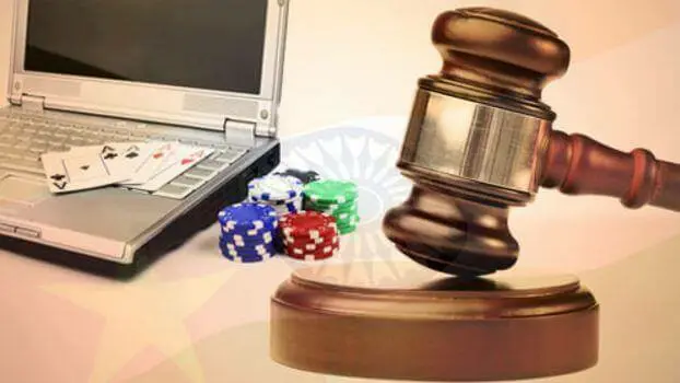 Image of a gavel by a laptop with chips online gambling laws USA