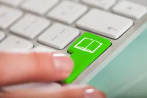 Image of laptop with green button