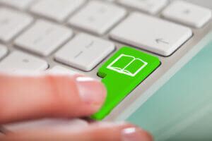 Image of laptop with green button